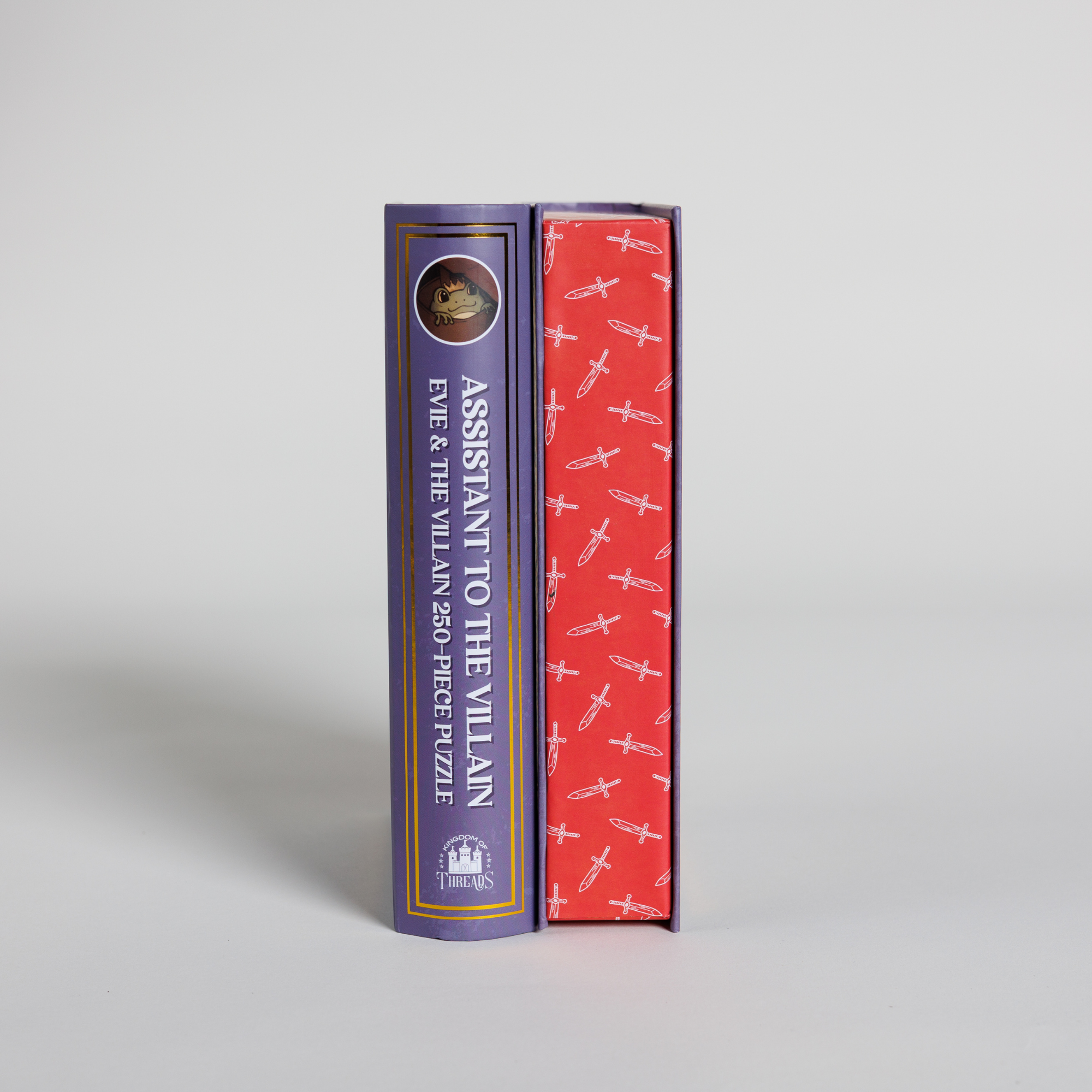 The Evie & Villain Keepsake Puzzle | Assistant to the Villain shown with its sword-patterned, book-shaped box.