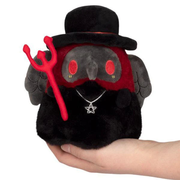 Snacker-sized Alter Ego Plague Doctor demon plush with red eyes, black hat, wings, trident, and pentagram necklace.