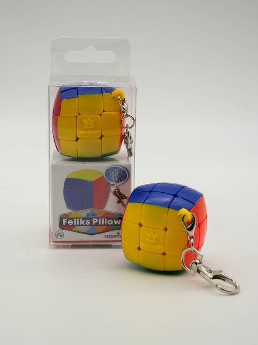 Mini yellow, blue, and red Mefferts Keychain puzzle in packaging labeled Mini Feliks Pillow.