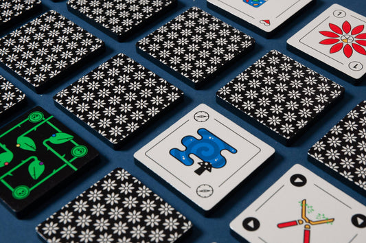 Kuzus Maze card game with black floral card backs, semi-cooperative play, travel-sized deck.