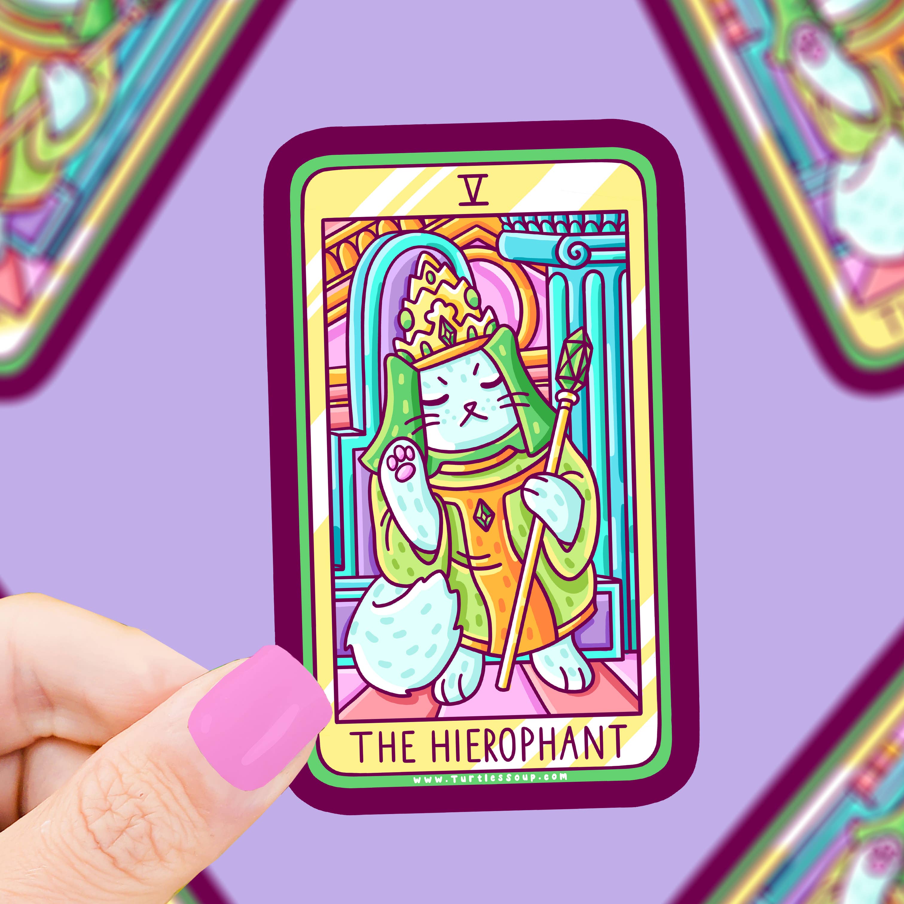 The Hierophant Cat Tarot Vinyl Sticker held by a pink-nailed hand against a purple background.