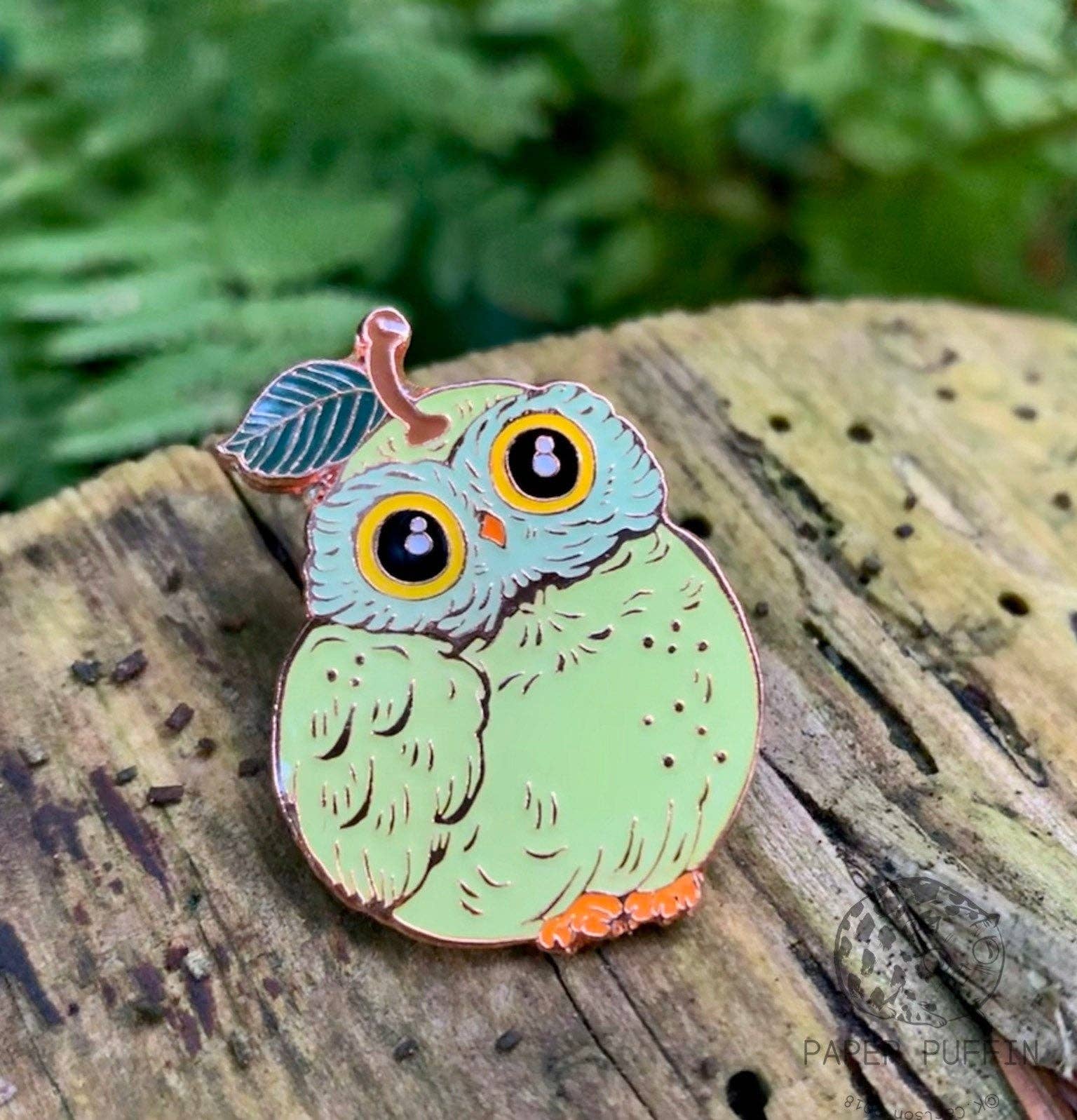 Light green round Pear Owl Cat enamel pin with a leaf on the owl’s head.