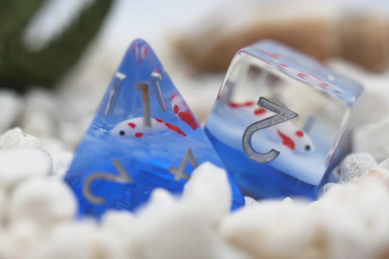 Koi Pond RPG Dice Set with two blue and clear dice containing tiny koi fish, resembling a miniature pond.