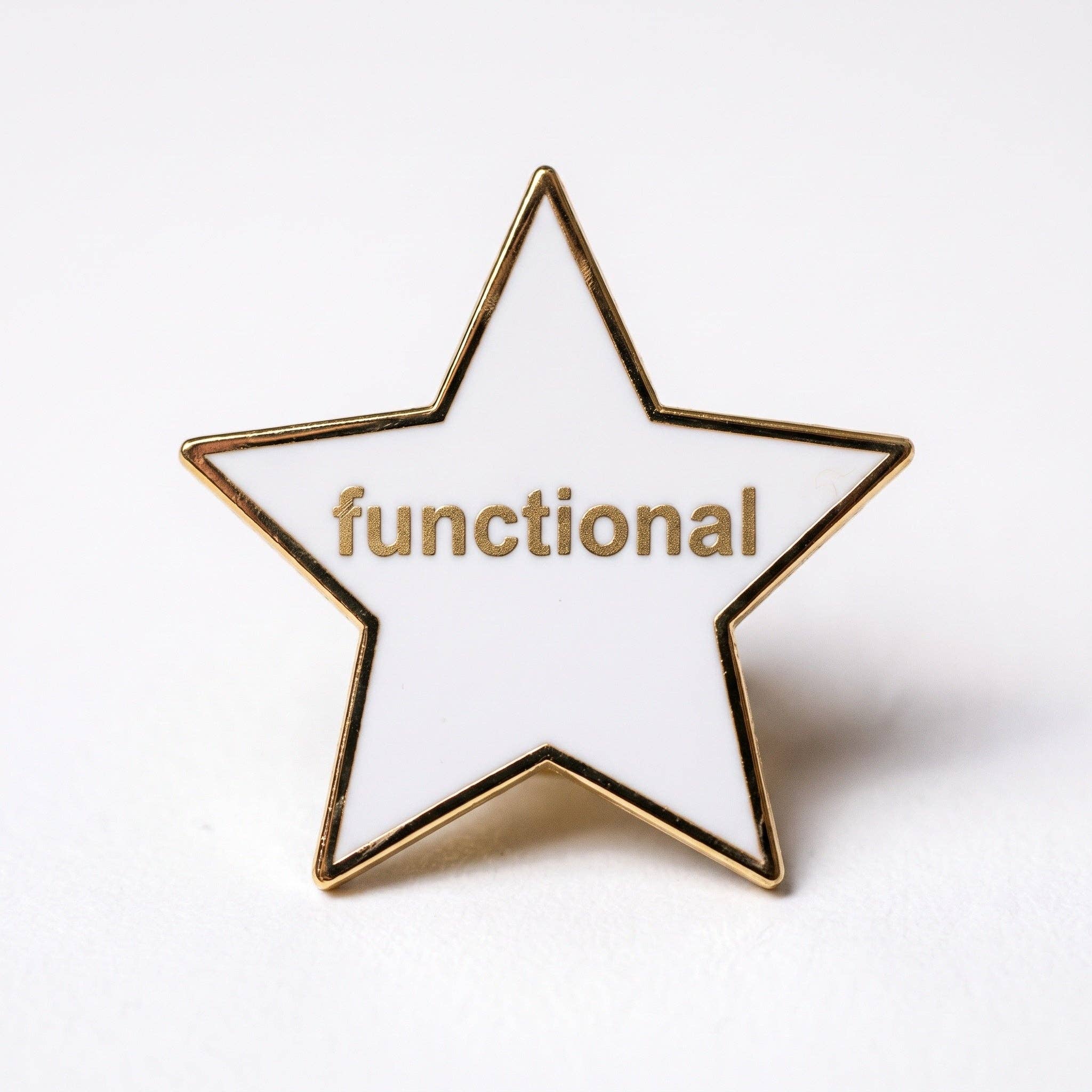White star-shaped hard enamel pin with gold trim and the word functional in gold lettering.
