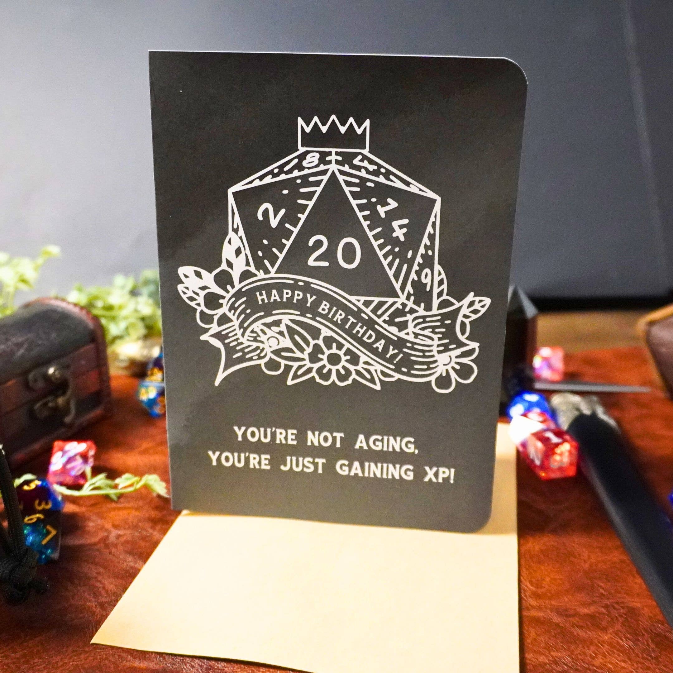 Youre Not Aging XP DnD Birthday Card, black with white D20 dice, text: Youre just gaining XP.