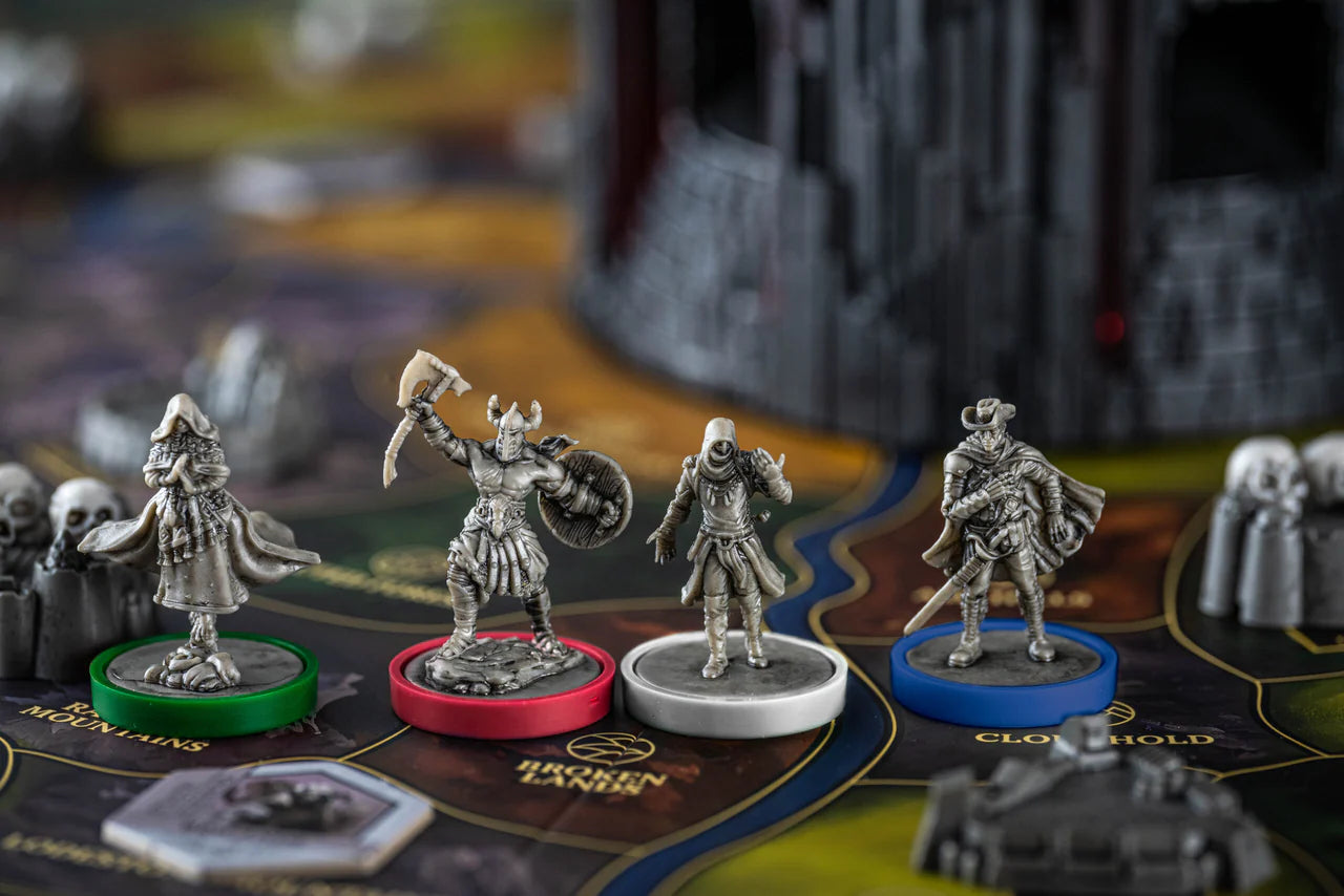 Four Return to Dark Tower board game miniatures on colored bases.