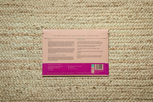 The Escape Room puzzle game The Ransom and instructions on a beige woven rug.