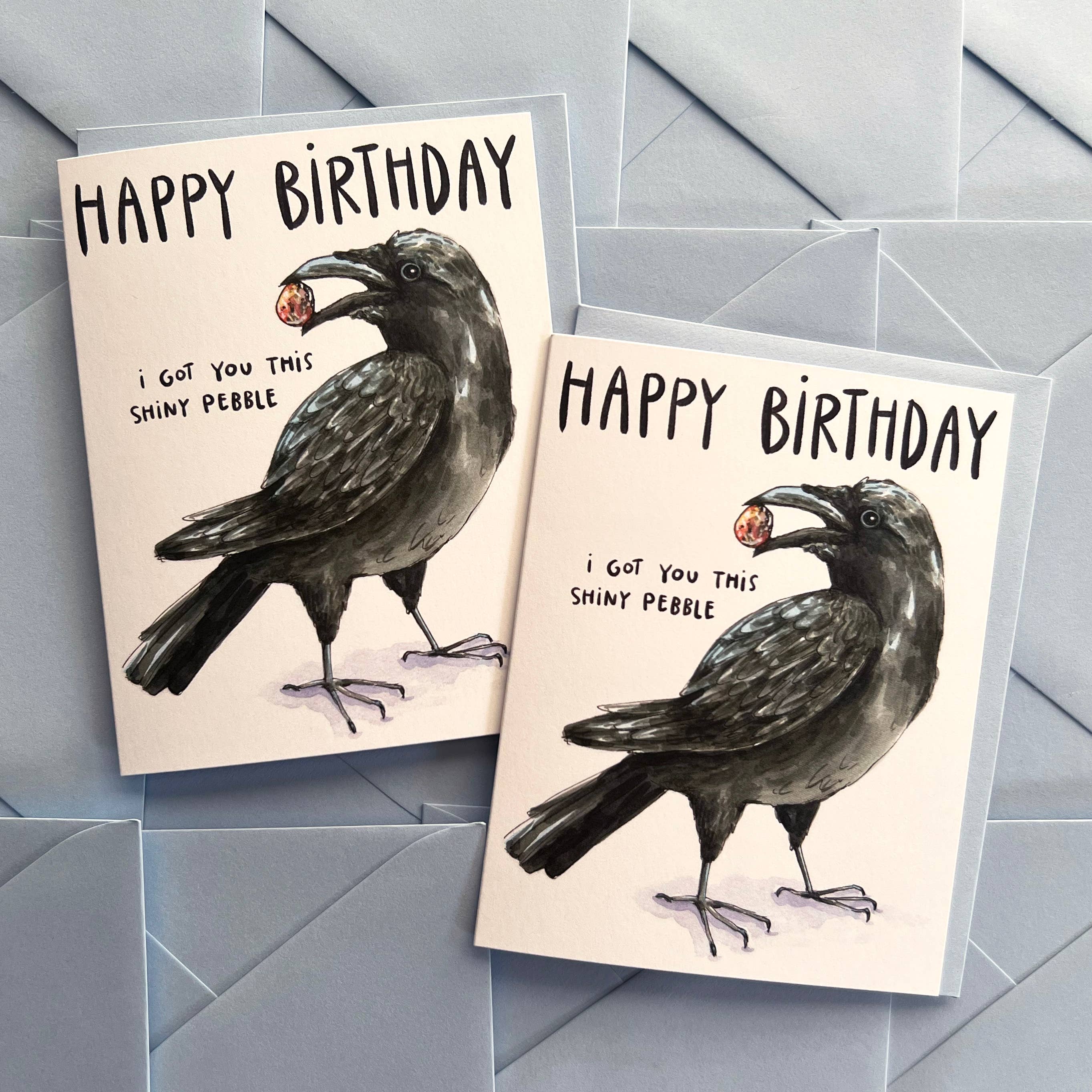 The Crow I Got You This Shiny Pebble Happy Birthday Card with watercolor crow and shiny pebble illustration.