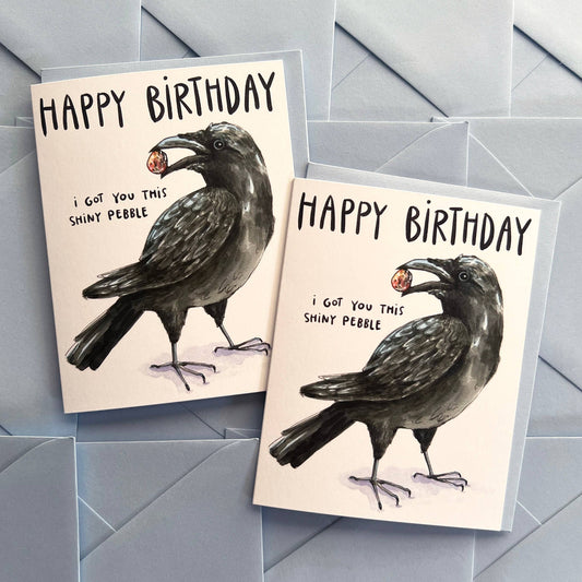 The Crow I Got You This Shiny Pebble Happy Birthday Card with watercolor crow and shiny pebble illustration.