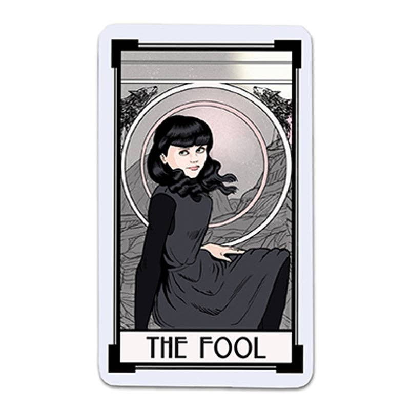 The Fool card from Christina Ricci’s Cat Full of Spiders Tarot Deck featuring a dark-haired woman in a dark dress.