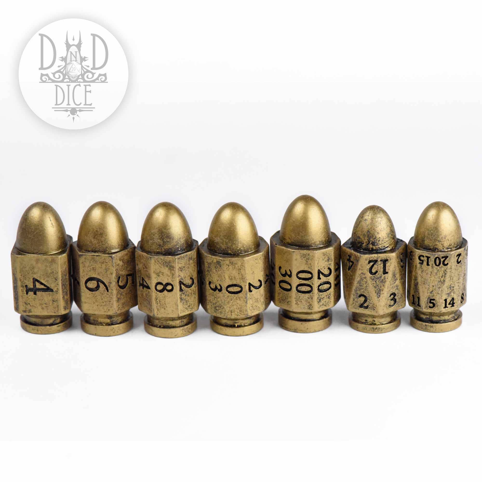 Set of seven bullet-shaped brass D&D dice, each numbered.