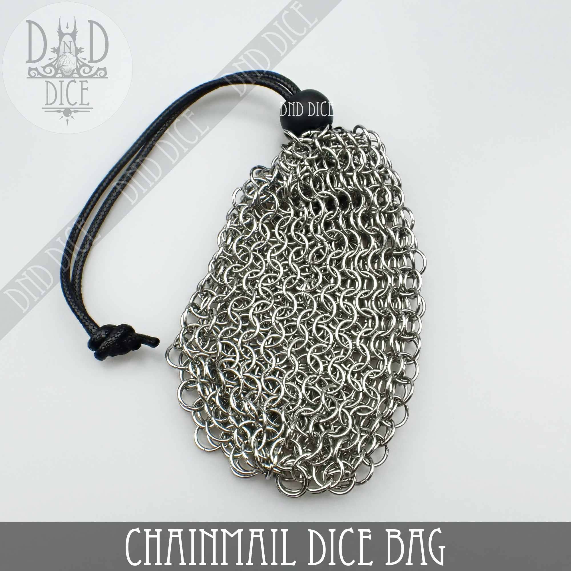 Chainmail bag with black drawstring and stainless steel dice box on white background.