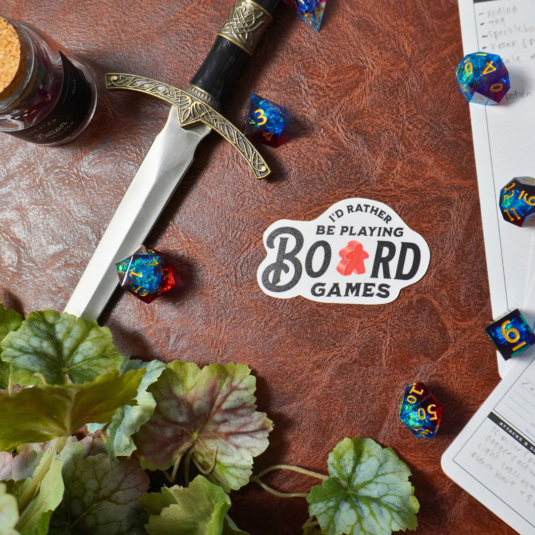 Id Rather Be Playing Board Games sticker with illustrations of games, dice, notepad, sword, and plant.