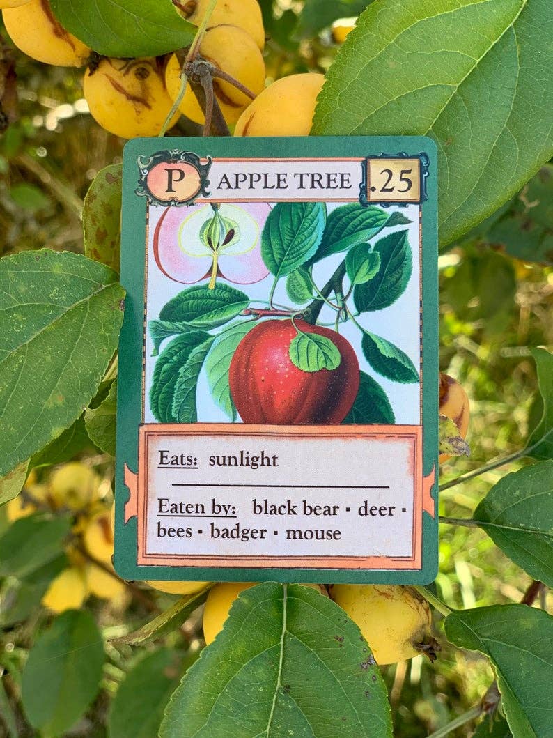 Ecologies Card Game card featuring an apple tree with green leaves, yellow fruits, and one red apple.