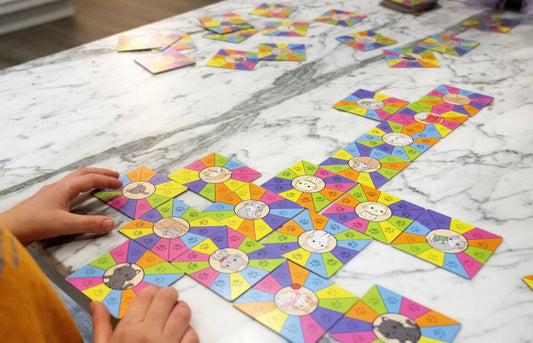 Kitty Litter Fast-Action Matching Game with colorful cards arranged by a child.