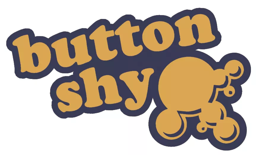 Button Shy Wallet Games logo with bold text and a yellow abstract shape.
