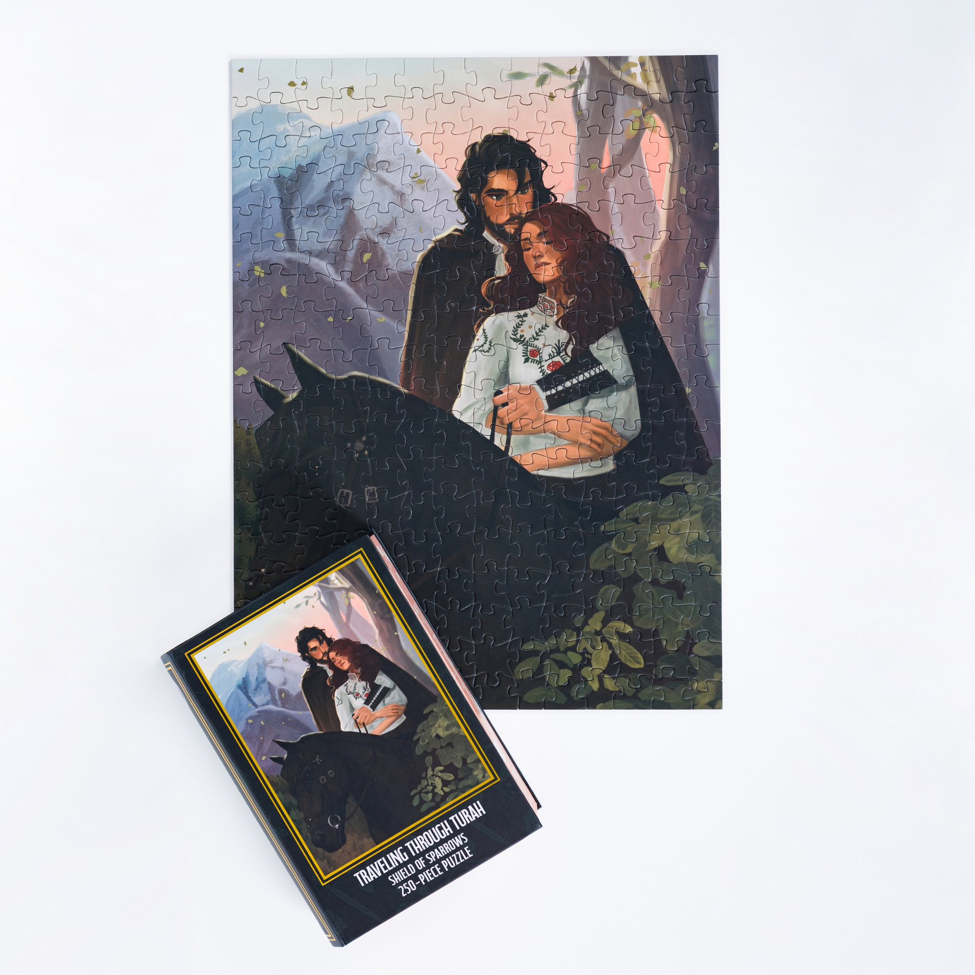 The Traveling Through Turah Keepsake Puzzle features a couple with a horse and is packaged in a book-shaped box.