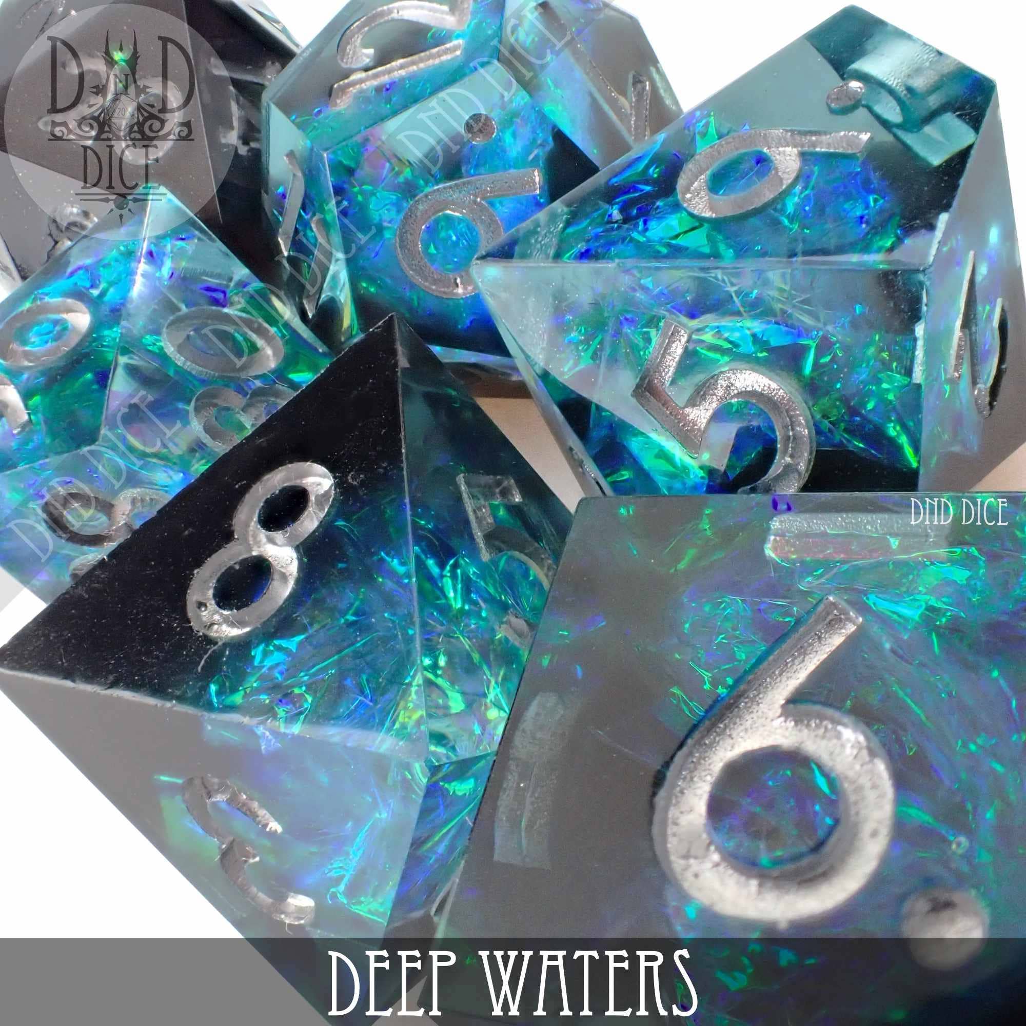 7-piece Deep Waters resin dice set with blue and green iridescent flakes and silver numbers.