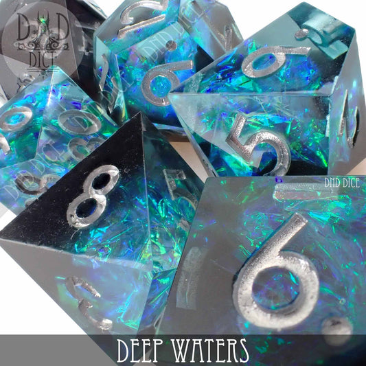 7-piece Deep Waters resin dice set with blue and green iridescent flakes and silver numbers.