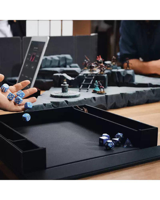 Dragon Shield RPG: Player Companion - Iron Grey dice tray with blue dice and RPG miniatures nearby.