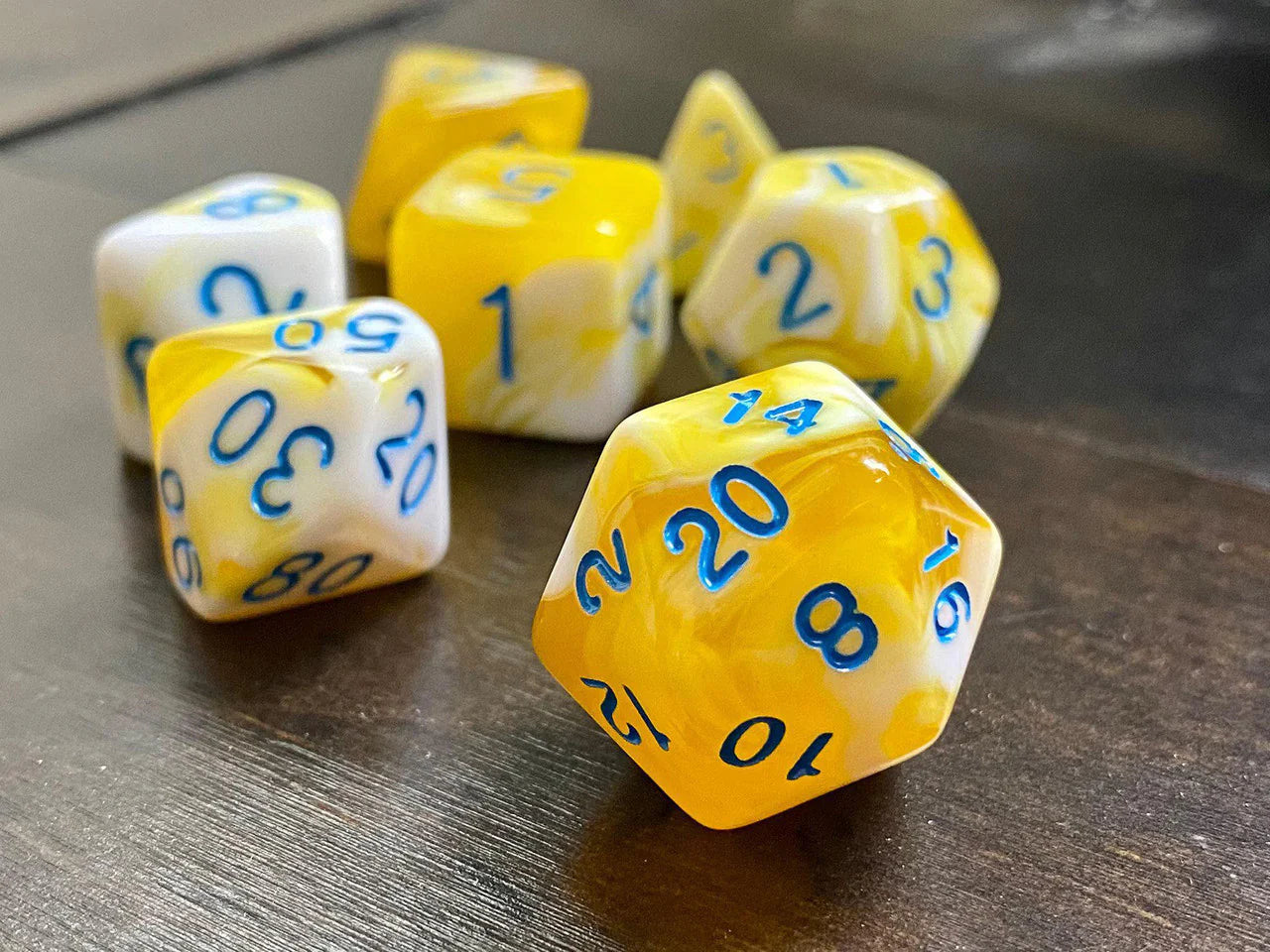 Frozen Butter RPG Dice Set: yellow and white marbled dice with blue numbers.