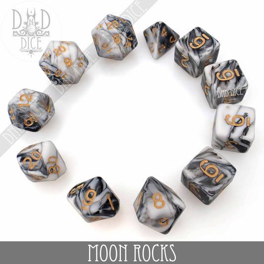 Moon Rocks 7 or 11 polyhedral dice set, marbled black, white, and gray with gold numbers, in packaging.