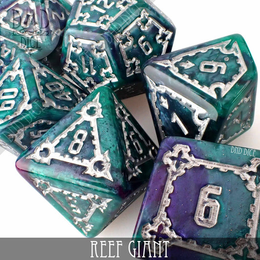 7-piece Reef Giant (Oversize) polyhedral resin dice set, teal and purple with silver numbers and ornate borders.