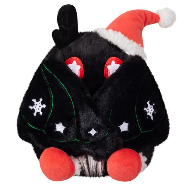 Mini Squishable Holiday Baby Mothman plush with red eyes, orange feet, Santa hat, and festive decorations.