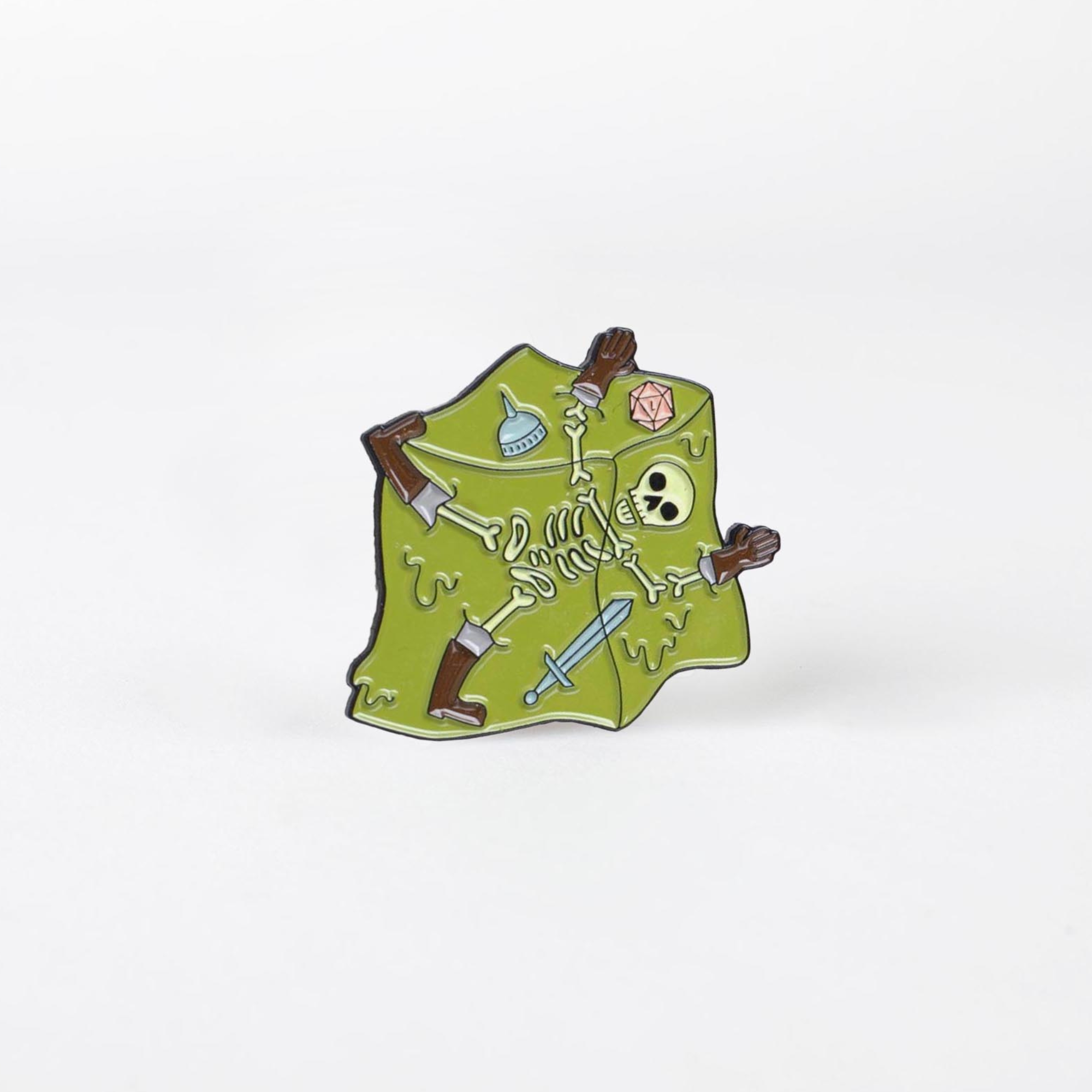 Eaten By a Gelatinous Cube enamel pin featuring a skeleton, weapons, helmet, and dice trapped in green slime.