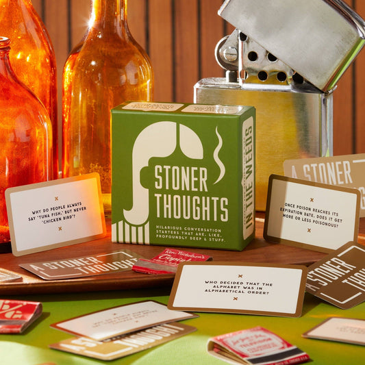 Brass Monkey Stoner Thoughts green box with question cards, bottles, and a large metal lighter nearby.