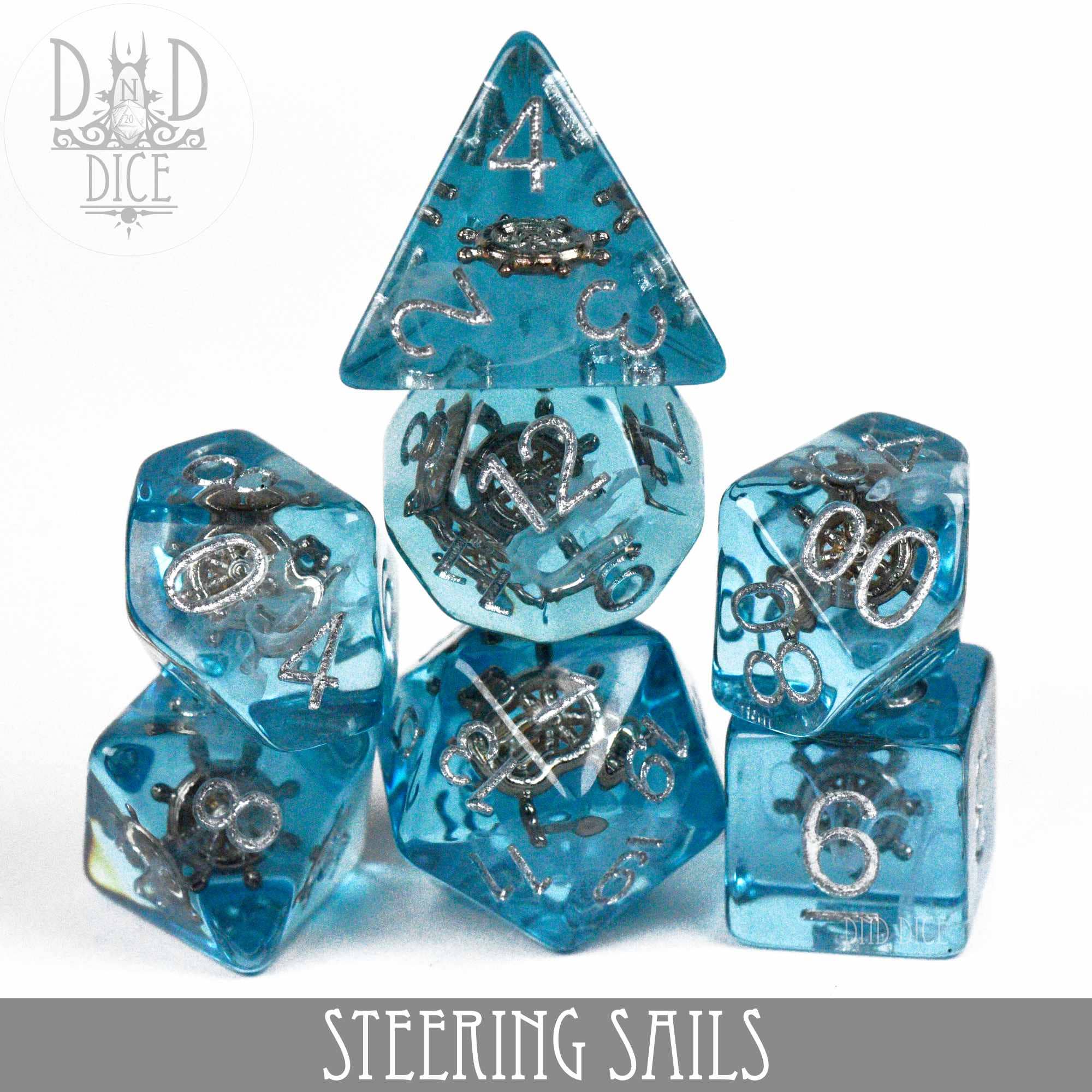 Steering Sails 7-dice set in blue translucent resin with silver numbers and nautical symbols.