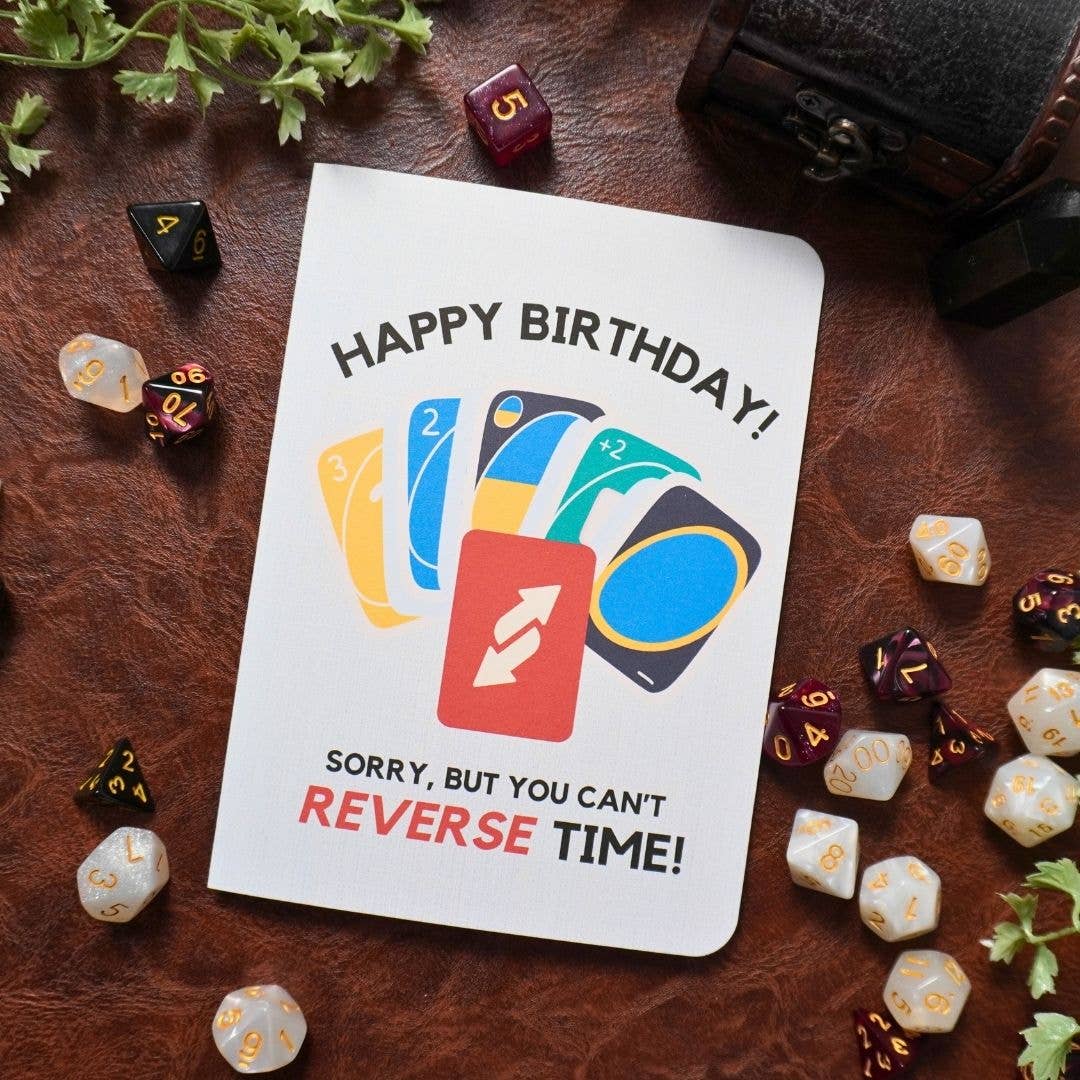 UNO birthday card with colorful dice and Happy Birthday Sorry, cant REVERSE TIME text, 5x7 inches.