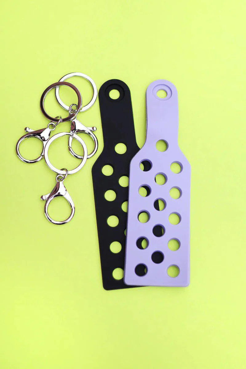 Two CHARM KEYCHAINS, one black and one lavender, each with three metal rings.