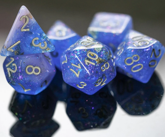 Blue & Pink Seabed Treasure Dice Set with gold numbers on a reflective black surface.
