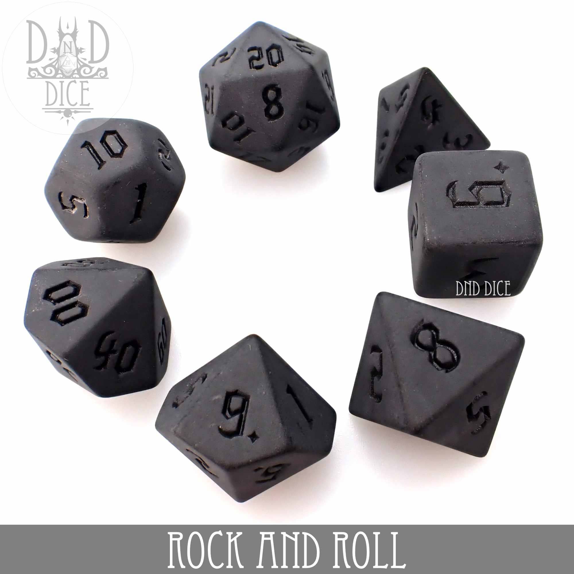 Seven black acrylic dice set, Rock and Roll variant.