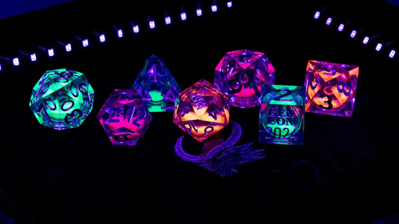 Gen Con 2024 Exclusive Liquid Core UV Reactive Set glowing under blacklight, with purple dragon design adjacent.