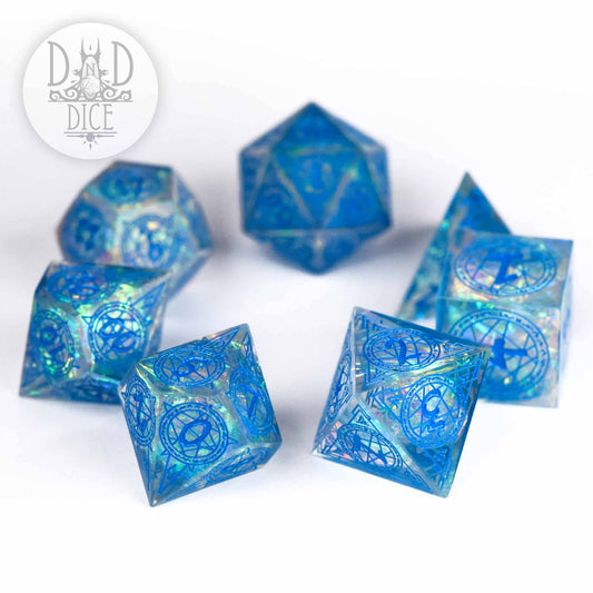 Set of six translucent blue resin dice, Crown of Magic (Handmade), featuring intricate designs.