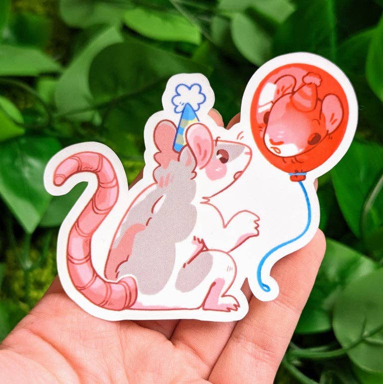 Waterproof sticker featuring a cartoon rat wearing a party hat and holding a red balloon, surrounded by green leaves.