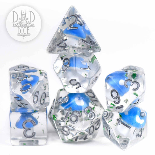 Seven clear resin dice with blue and green accents. Fungal Field 7 Dice Set. DND DICE logo in top left corner.