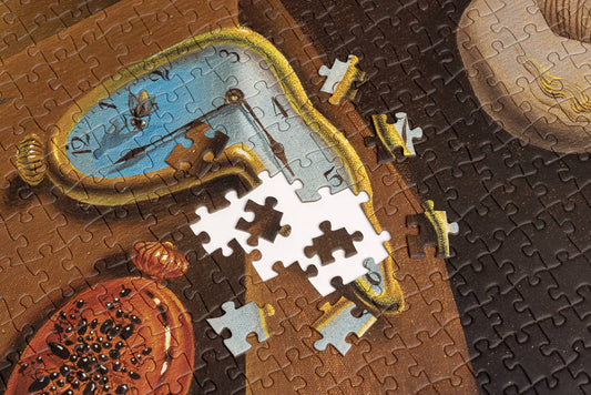 Puzzle - Salvador Dali - Persistence of Memory, close-up with missing pieces visible at the center.