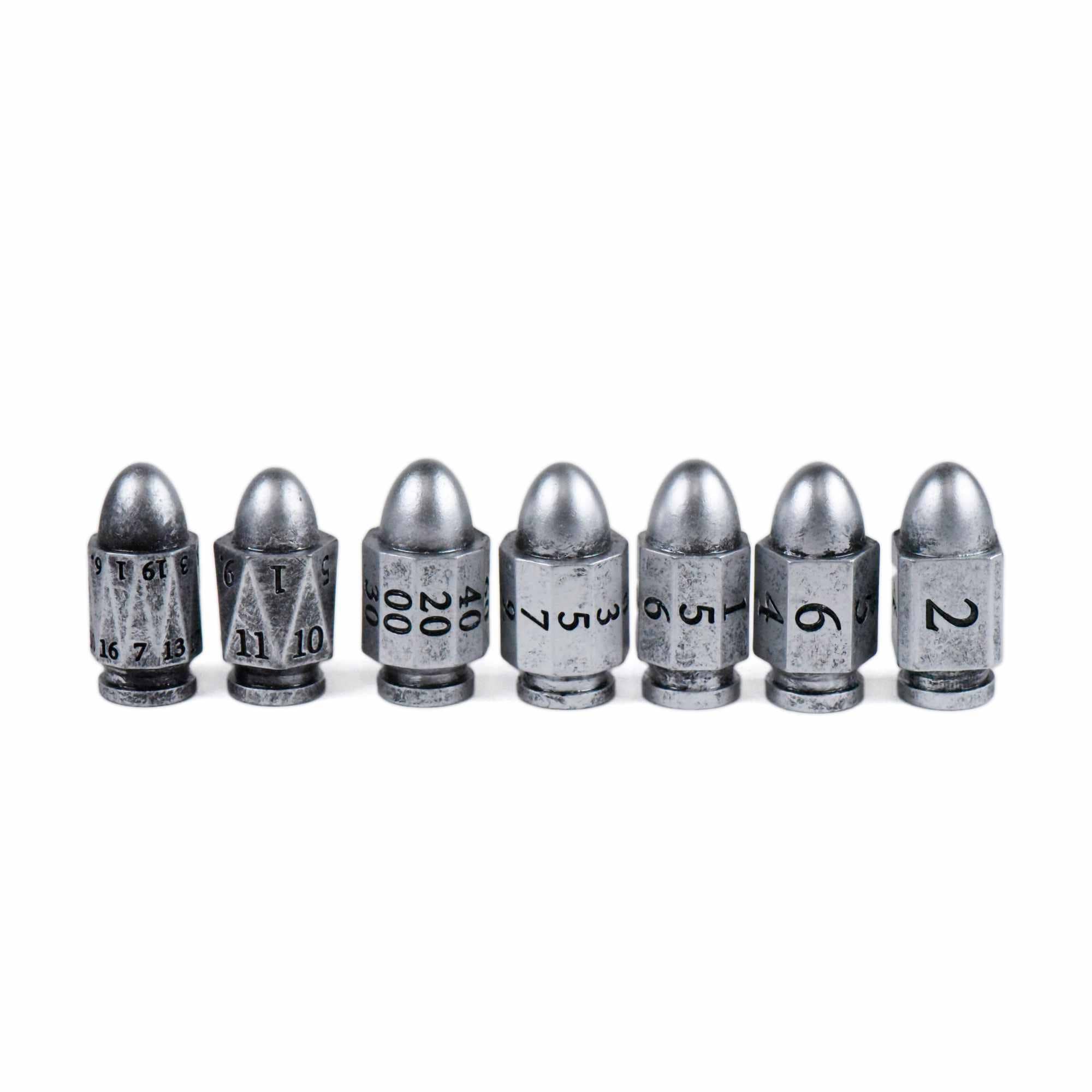Seven silver bullet-shaped metal dice, each numbered; Silver Bullets 7-dice set for tabletop gaming.