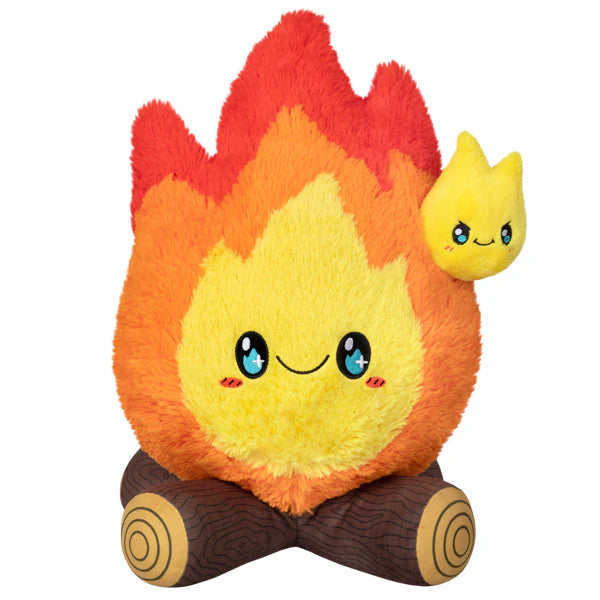 Squishable Campfire plush toy shaped like a smiling campfire with a yellow flame and two logs.