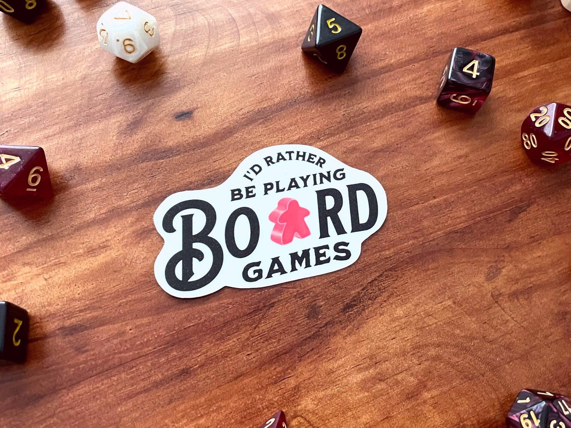 I’d Rather Be Playing Board Games sticker featuring dice and board game elements.