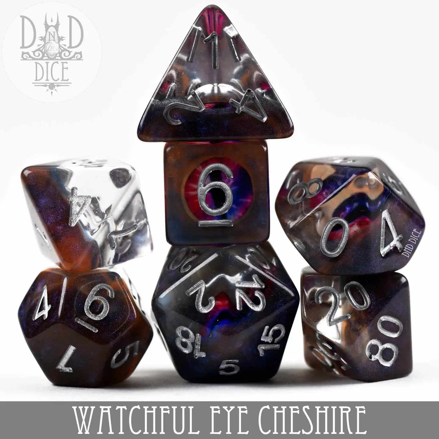 The Watchful Eye - Cheshire Dice Set with polyhedral dice and silver numbers, including a D20 and D6.