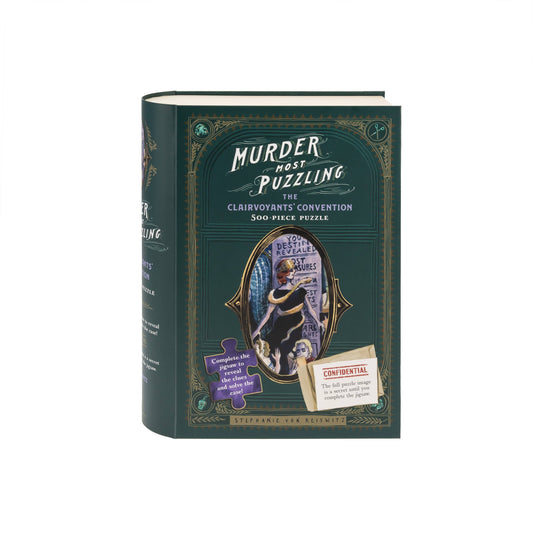 Murder Most Puzzling: The Clairvoyants Convention 500-piece puzzle in a green book-shaped box.