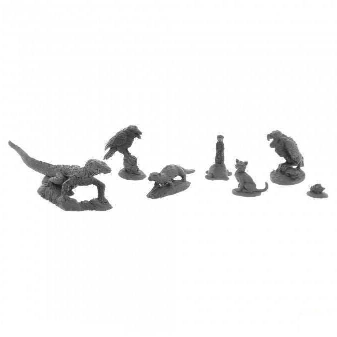 Dungeon Dwellers Familiars Miniatures set with 7 small gray figures: dinosaur, birds, cat, frog, and rat.
