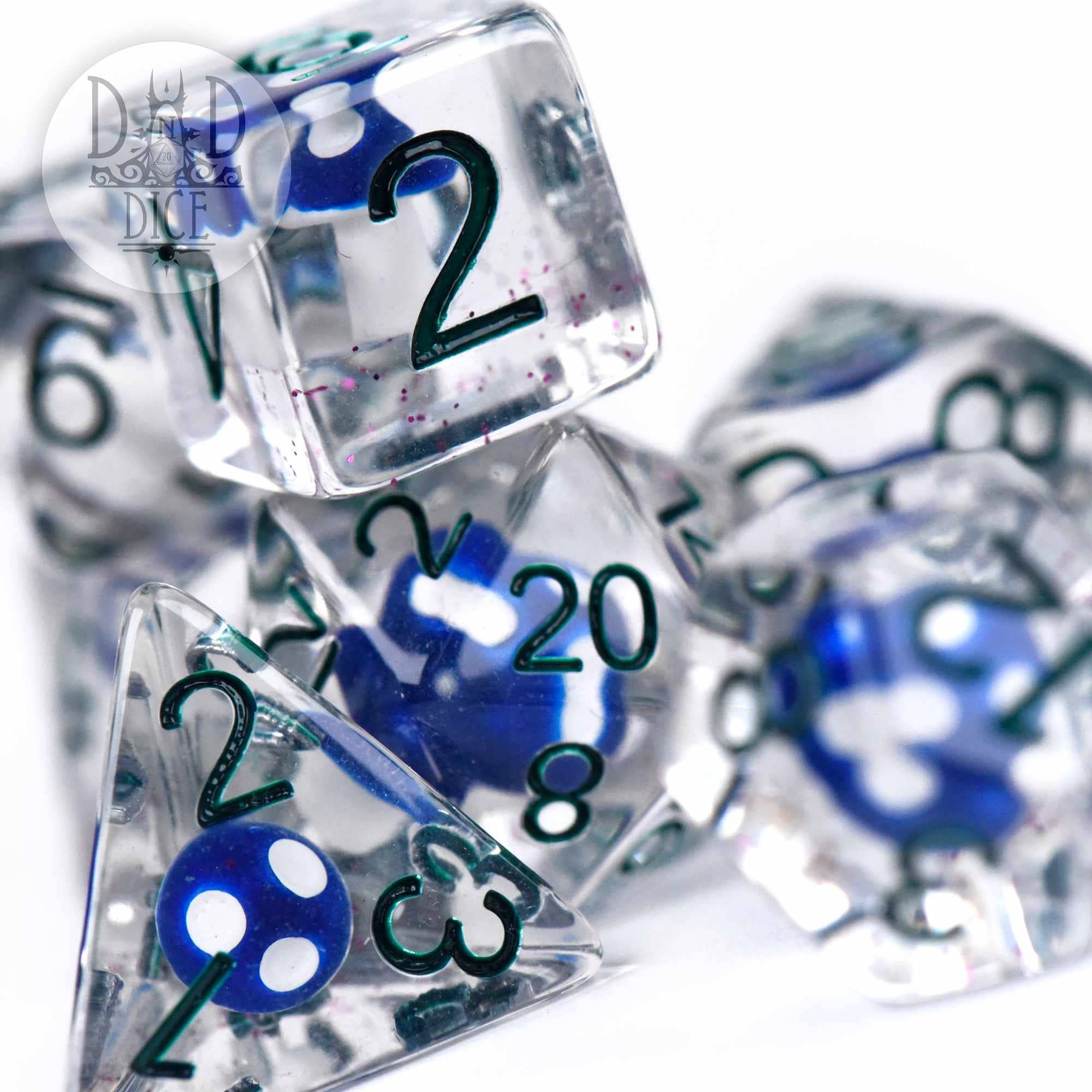 Fungal Spores resin 7-dice set with clear shapes, blue-white centers, and green numbers for tabletop gaming.