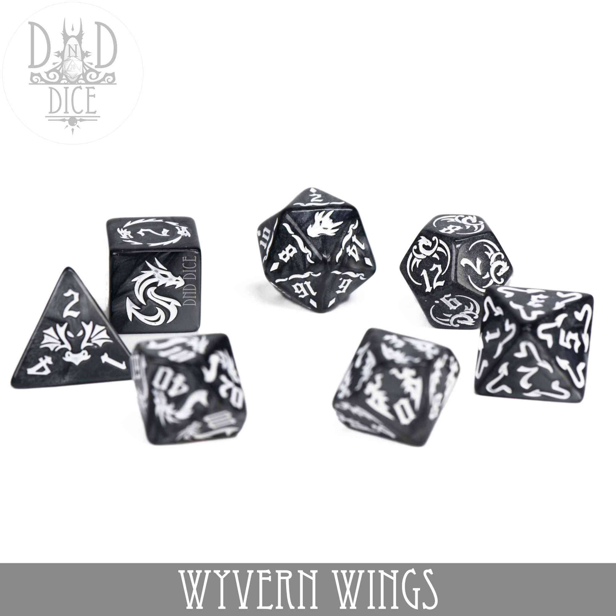 Wyvern Wings 7-piece polyhedral dice set in black and white acrylic with dragon and wyvern designs.