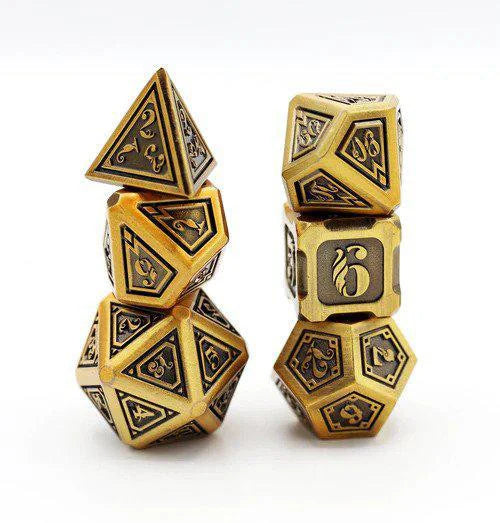 The Alchemist Metals RPG Dice Set: Gold, includes ornate gold and black metal dice stacked together.
