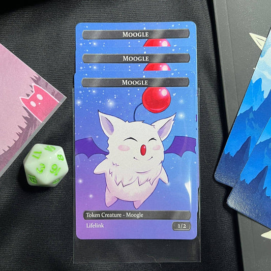 Four Moogle hero tokens displayed on a playmat with green d20, blue Magic cards, and card sleeves.
